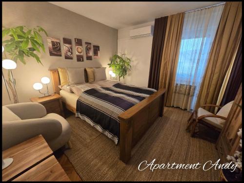 a hotel room with a bed and a couch at Apartment Andy in Medvode