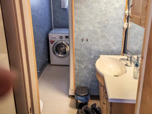 a bathroom with a sink and a washing machine at 8 person holiday home in isfjorden-By Traum in Torvik