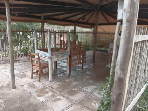 a table and chairs under an umbrella on a patio at Pennington Beach Cottage Holiday accommodation in Pennington