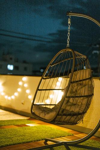 a bird cage hanging in front of a train at みらいステイ牛深 - サウナとバーベキューを楽しむオーシャンビューの一棟貸し別荘 in Amakusa