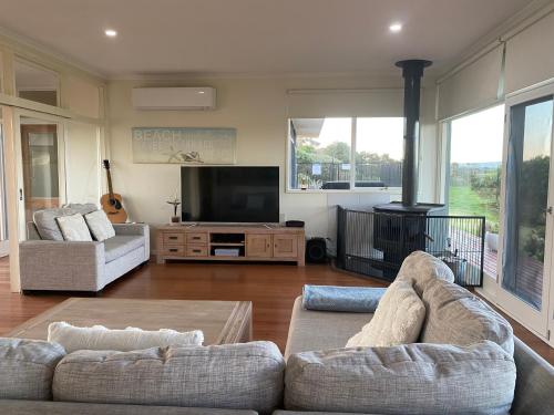 a living room with two couches and a fireplace at Driftwood Villas in Sandy Point