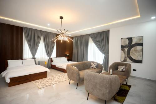 a hotel room with a bed and two chairs at Villa Hills Hotel 