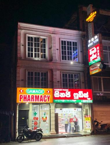 a motorcycle parked in front of a pharmacy at The Empire Inn in Ratnapura
