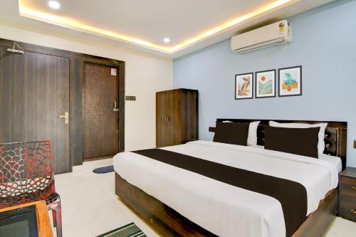 a bedroom with a large bed in a room at Hotel O S-Square in Bhadrak