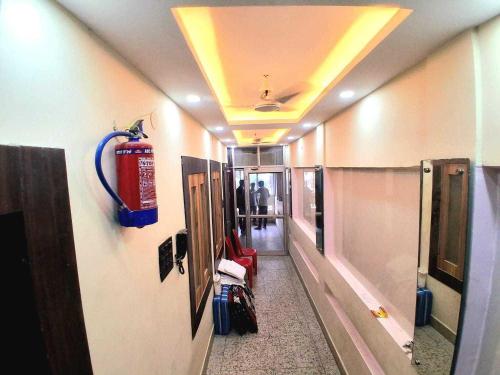 a hallway with a fire extinguisher on the ceiling at Hotel O Raj Mahal INN in Gulzārbāgh