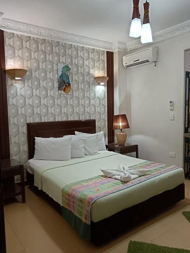 a bedroom with a large bed with at Bonne Vie Hotel in 6th Of October