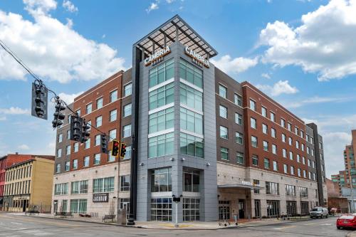 a building on a city street with a traffic light at Cambria Hotel Louisville Downtown-Whiskey Row in Louisville