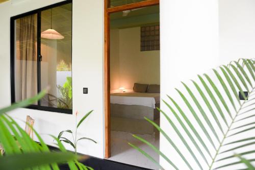 a view of a bedroom through a glass door at Nova Surf House in Matara