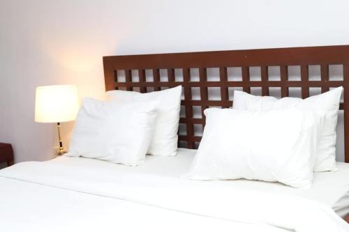 Ένα ή περισσότερα κρεβάτια σε δωμάτιο στο OZI Homes Guaranteed Comfort