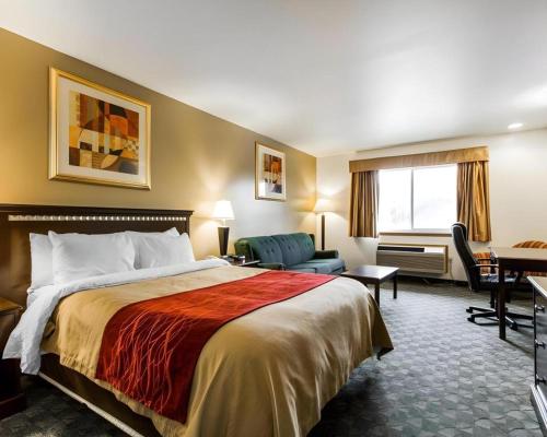 a hotel room with a bed and a desk at Quality Inn in Edgerton