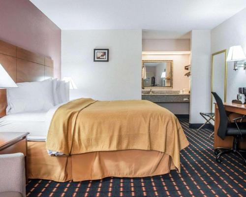 a hotel room with a bed and a desk at Quality Inn in Marianna