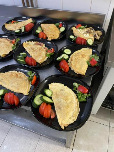 a bunch of plates of food on a stove at Pensiunea El Greco in Axente Sever