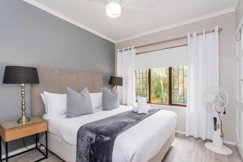 a bedroom with a large white bed and a window at 39 Kingston in Ballito