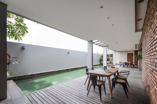 an indoor pool in a house with a table and chairs at Cove Heritage in Binong