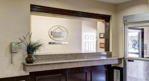 a mirror in a room with a counter and a phone at Suburban Extended Stay La Place in Laplace