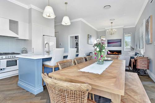 a kitchen and dining room with a table and chairs at Stellaview Estate in Mitchells Flat