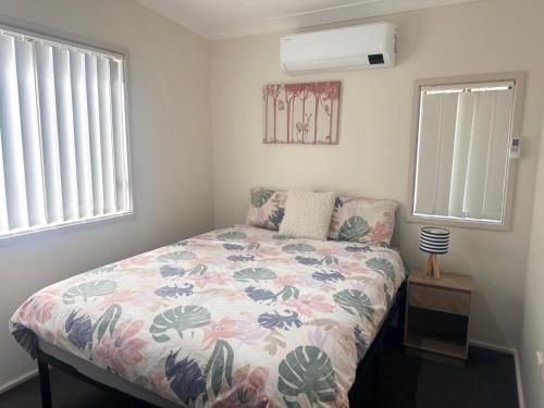 a bedroom with a bed with a floral comforter at Charlestown Central 7 Bedrooms Front House and Back Unit in Charlestown