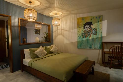 a bedroom with a bed and a mirror and lights at Lugadia Villas in El Nido