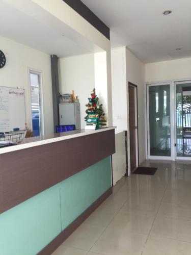 a kitchen with a christmas tree in the middle of a room at Banchaitalay Room in Rayong