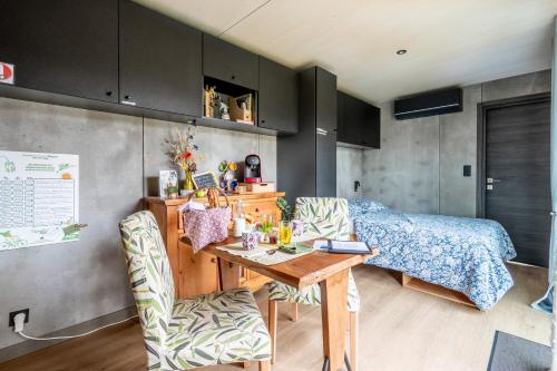 a bedroom with a bed and a table and chairs at O Petit Jardin in Cholet