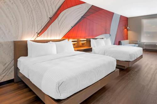 two beds in a room with a tent at Cambria Hotel & Suites Plymouth in Plymouth