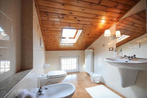 a bathroom with a white toilet and a sink at Cà Lisa in San Fedele Intelvi