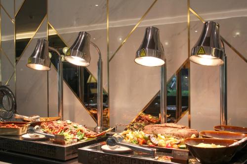 a buffet with many different types of food and lights at Ascott Menteng Jakarta in Jakarta