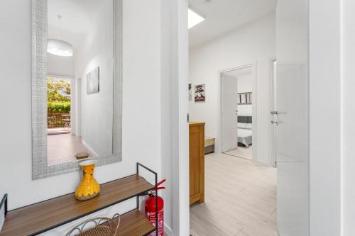 a living room with a mirror and a table at Appartamento Matteo in Pula