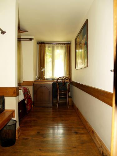 a room with a chair and a desk and a window at Hotel Empress Zoe in Istanbul