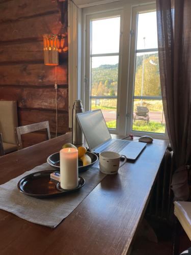 a table with a laptop computer on top of it at Bondasgården in Lima