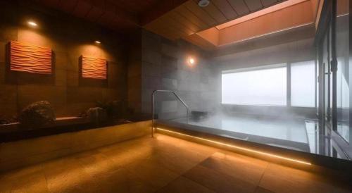 a bathroom with a bath tub and a window at KEIKYU EX INN Haneda Innovation City 2 minutes walk from HICity Exit of Tenkubashi Station in Tokyo