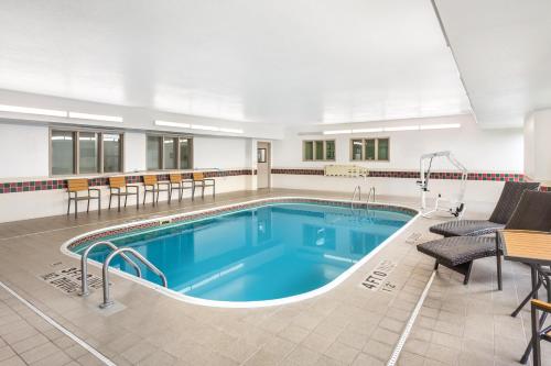 a pool in a hotel room with chairs and a table at Sleep Inn Missoula Southgate in Missoula