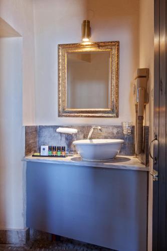 a bathroom with a sink and a mirror at Byzantino Boutique Hotel in Monemvasia