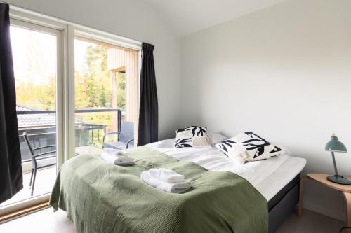 a bedroom with a bed with towels on it at Brand new house with four bedrooms, parking, sauna, patio in Vantaa