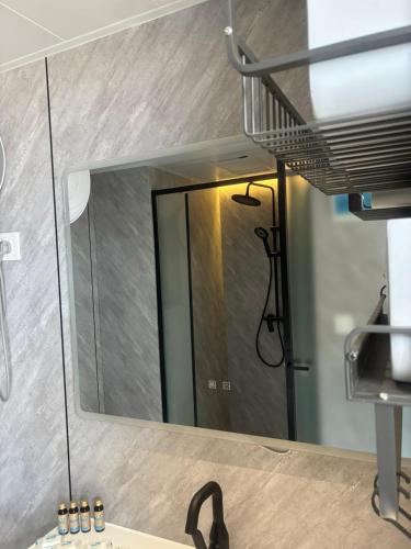 a mirror on a wall above a bathroom sink at Space Capsules in Albena