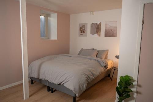 a bedroom with a bed and a mirror at Stvg centre, Heart of the city, 3 Bedroom in Stavanger