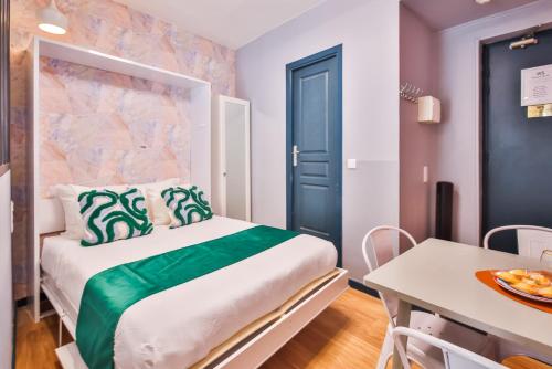 een kleine kamer met een bed en een tafel met een bord eten bij WS Montmartre - Sacré Coeur in Parijs