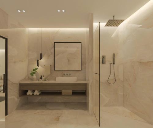 a bathroom with a sink and a glass shower at The Wine Suites in Rhodes Town