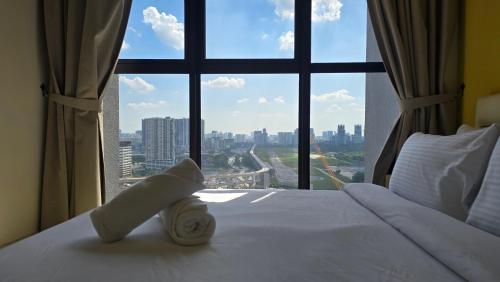 a hotel room with a bed with a large window at Trion Sky Suite KL in Kuala Lumpur