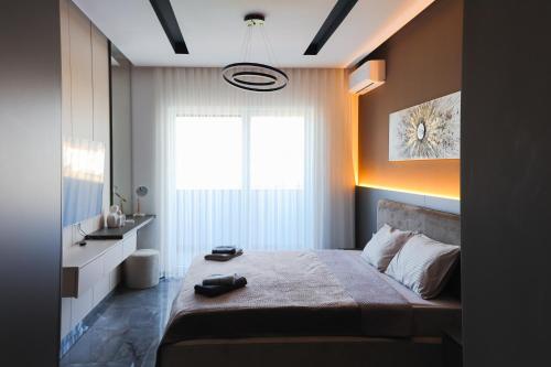 a bedroom with a large bed and a window at Adler Apartments in Prizren
