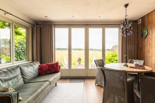 a living room with a couch and a table at Holiday home Landelijk Amsterdam in Amsterdam