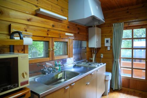 a kitchen with a sink and a stove at Sakata Log House - Vacation STAY 32306v in Sakata