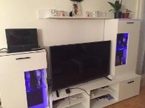 a flat screen tv sitting on a white entertainment center at Schöne Suite in der City of Basel in Basel