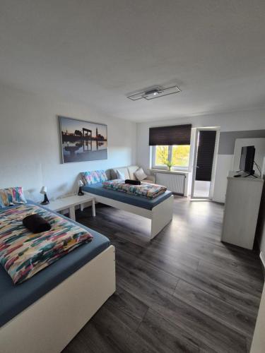 a living room with two beds and a couch at Apartment an der Weser in Bremerhaven