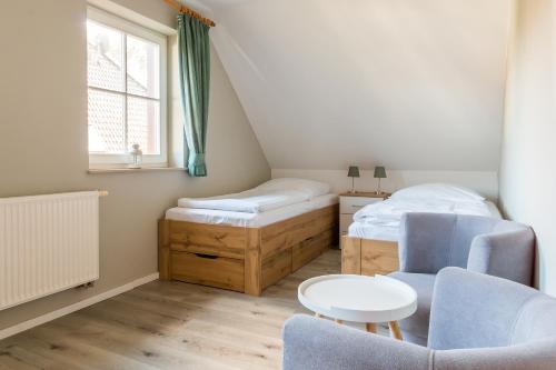 a bedroom with a bed and a table and chairs at Jagdhaus Prerowstrom in Jagdhaus