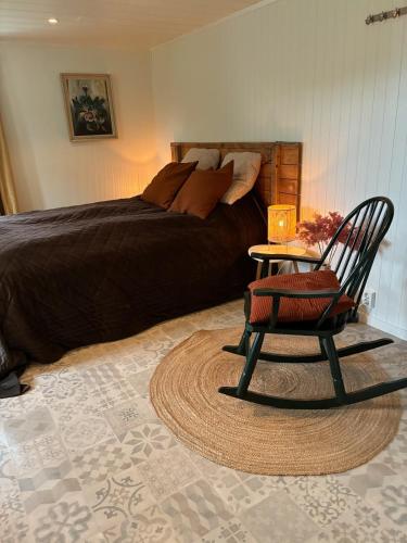 a bedroom with a bed and a chair and a table at Apartment Senja in Senja