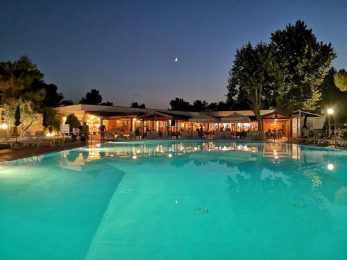 a large swimming pool at night at Futura Club Albatros in Lesina