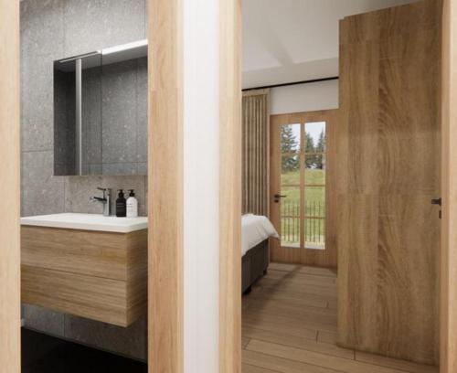 a bathroom with a sink and a bed at Alpen Lodge Kirchberg in Kirchberg in Tirol