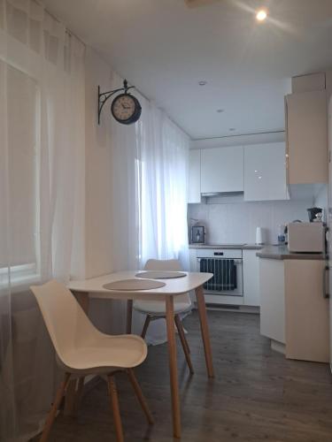 a small kitchen with a table and chairs in a room at Tallinna mnt 15 Apartament in Narva