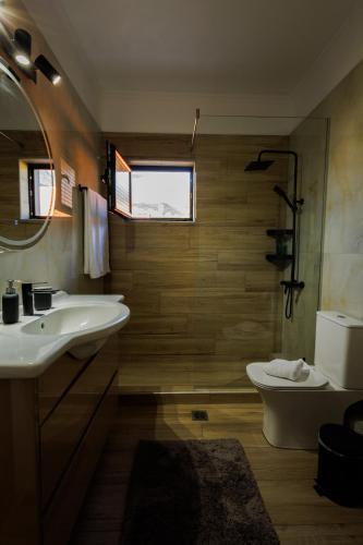 a bathroom with a sink and a toilet at White lavender house in Konitsa